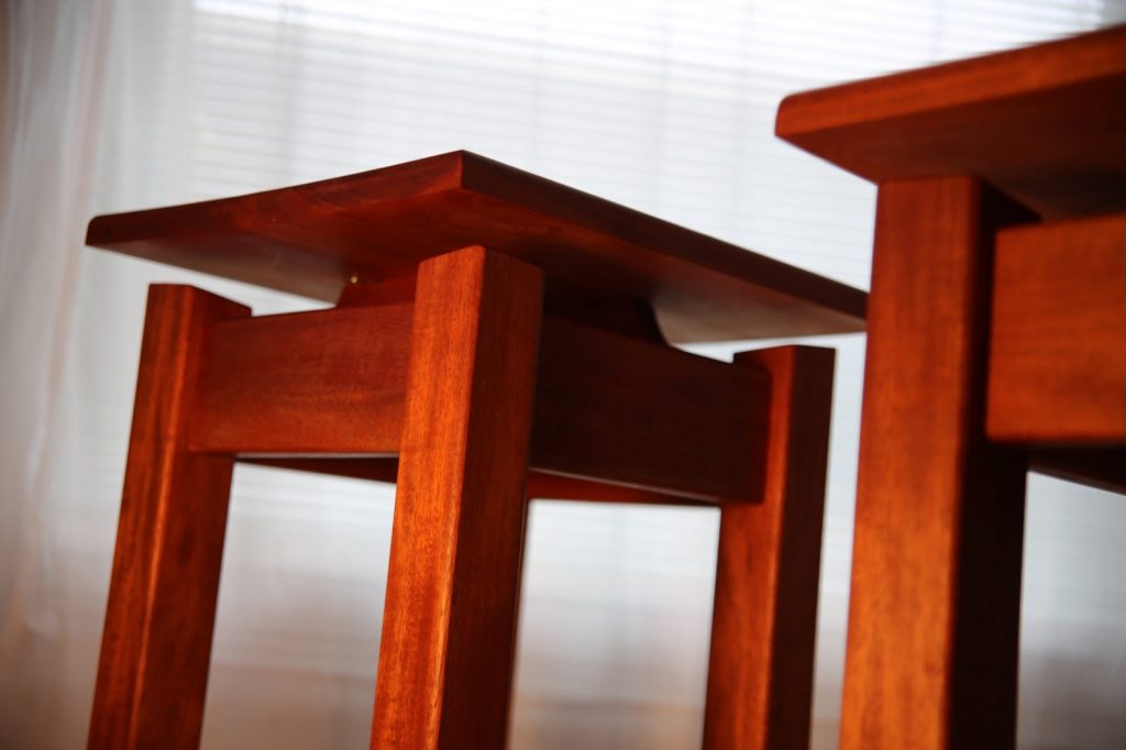Matching bedside tables with Mahogany lift tops.