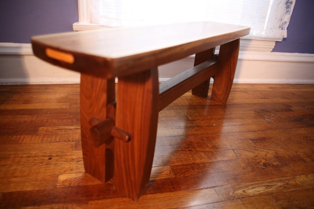 Narrow Bench in solid walnut with ash accent. “Notch and pin” joinery